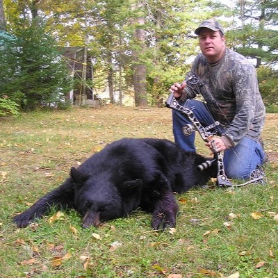 bow hunter with big black bear in Wisconsin